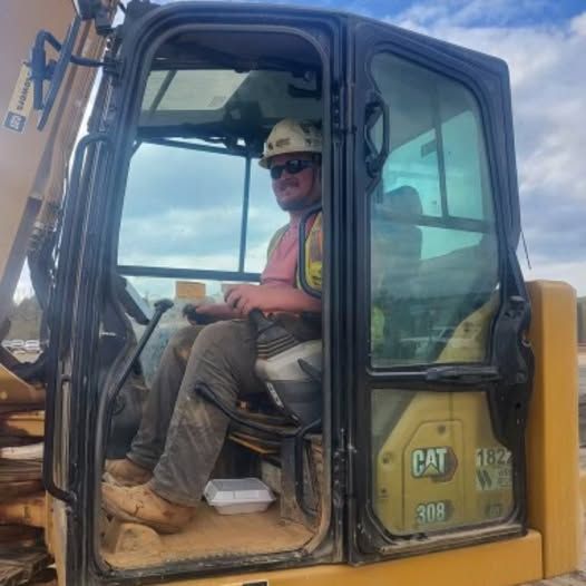 Operator Ethan West in his CAT mini excavator on the job site in Cartersville, GA