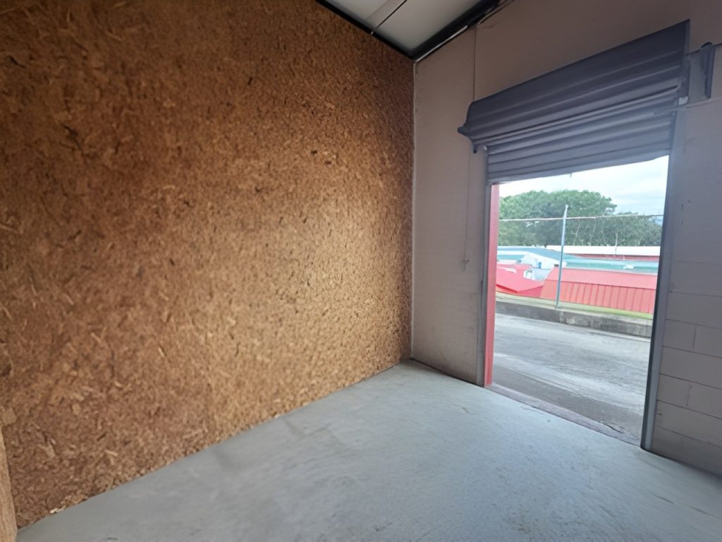 Inside a 10x12 storage unit looking out through the open roll-up door
